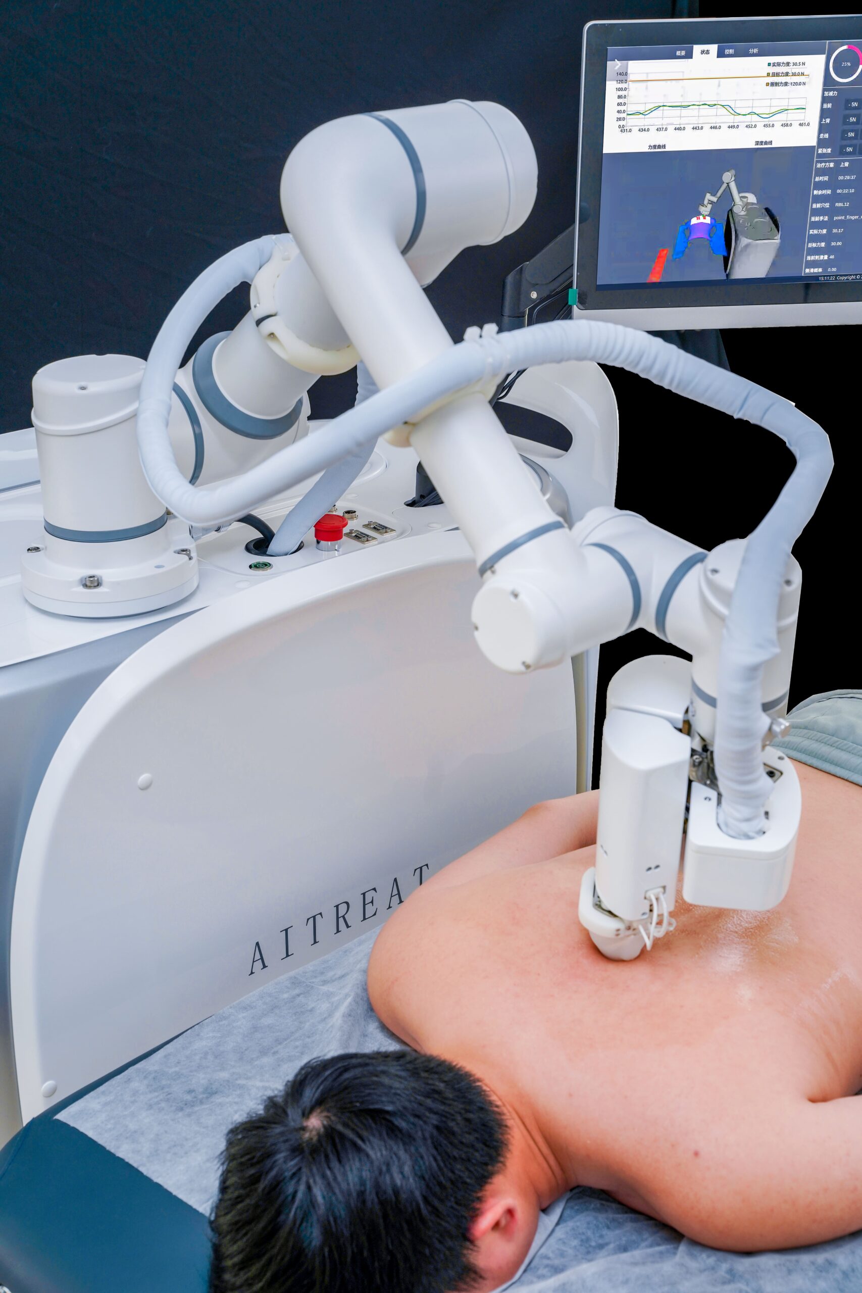 AI-powered EMMA TCM massage robot performing automated Tuina therapy on a patient’s back with real-time monitoring on screen